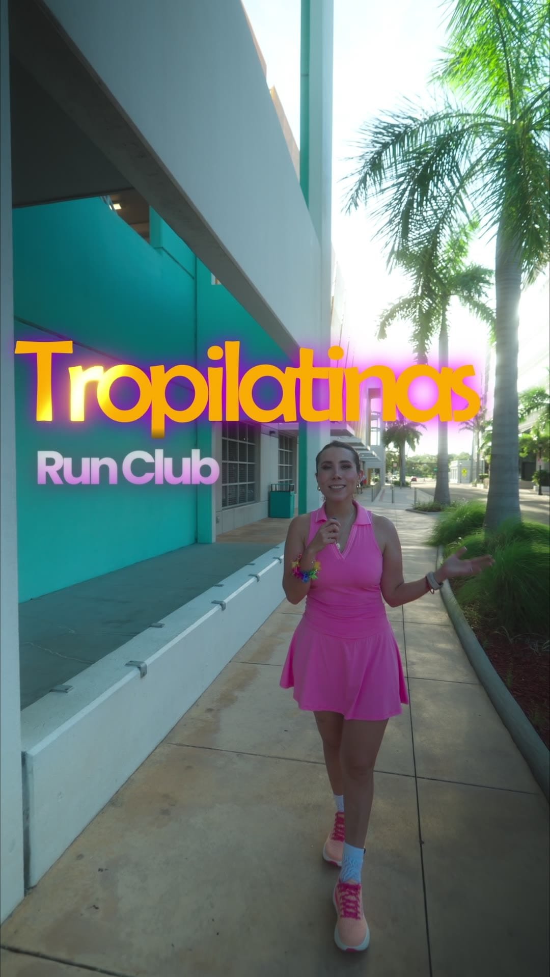 Founder of the Tropi Latina Run Club walking towards camera with the club title graphic on screen